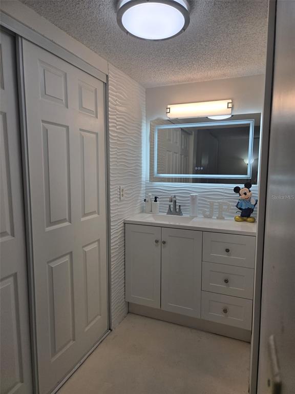 9410 Live Oak Place, Unit 103 Davie, FL 33324 - Photo 23 of 49 a bathroom with a double vanity sink and mirror