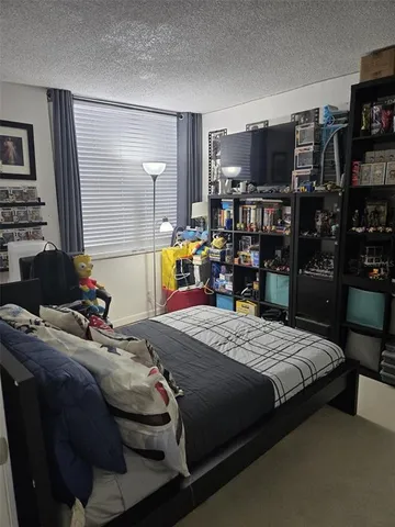 a bedroom with a bed and a television