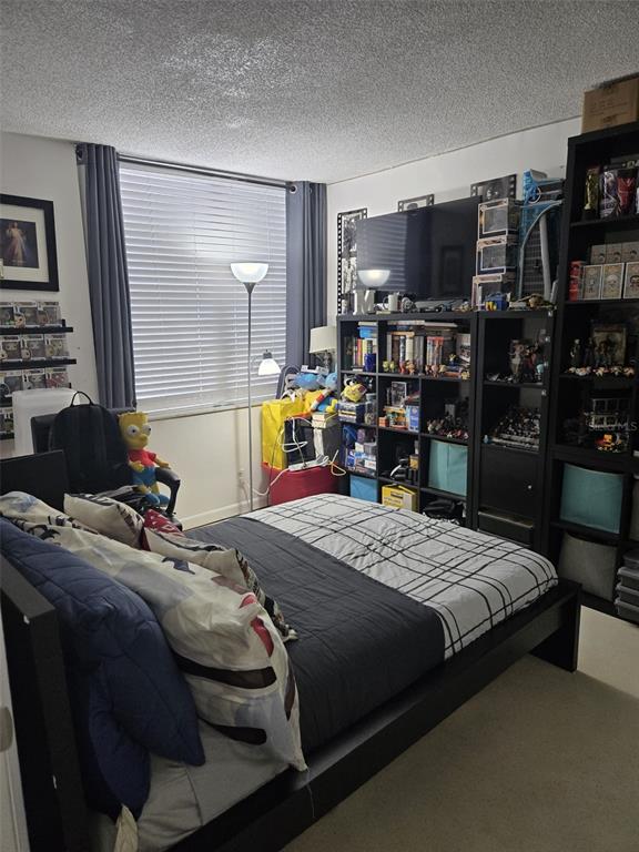 9410 Live Oak Place, Unit 103 Davie, FL 33324 - Photo 29 of 49 a bedroom with a bed and a television