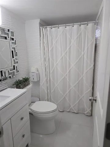 a white toilet sitting next to a bathroom sink