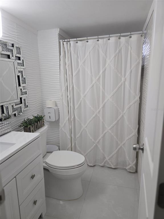 9410 Live Oak Place, Unit 103 Davie, FL 33324 - Photo 32 of 49 a white toilet sitting next to a bathroom sink