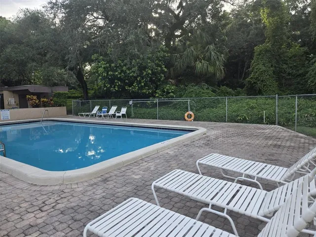 a view of a swimming pool with a patio