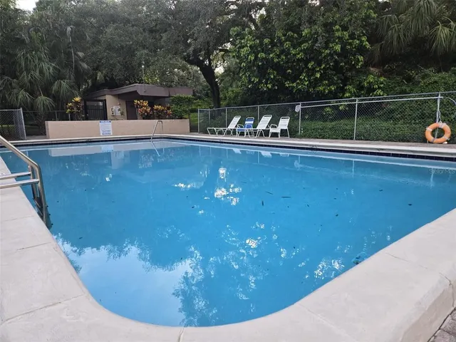 a view of a swimming pool with a yard