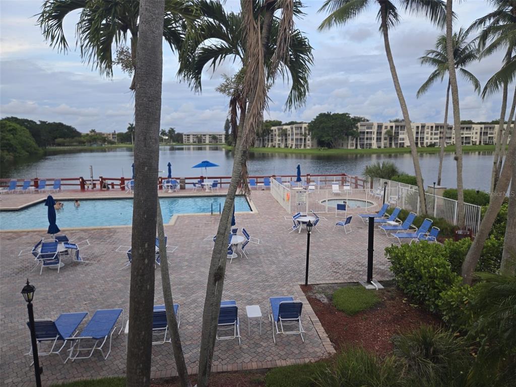 9410 Live Oak Place, Unit 103 Davie, FL 33324 - Photo 48 of 49 a view of a swimming pool and lounge chairs