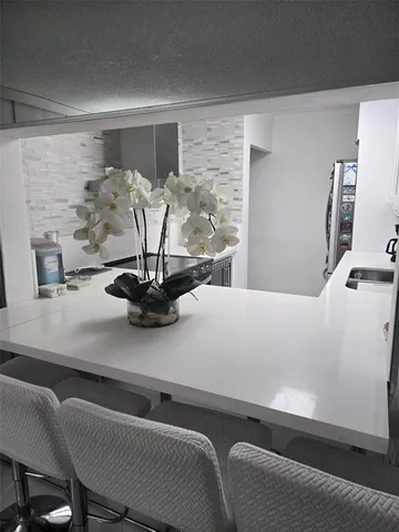 a view of a dining room with furniture and a potted plant
