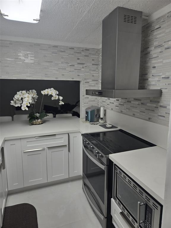 9410 Live Oak Place, Unit 103 Davie, FL 33324 - Photo 8 of 49 a kitchen with stainless steel appliances a sink stove and cabinets