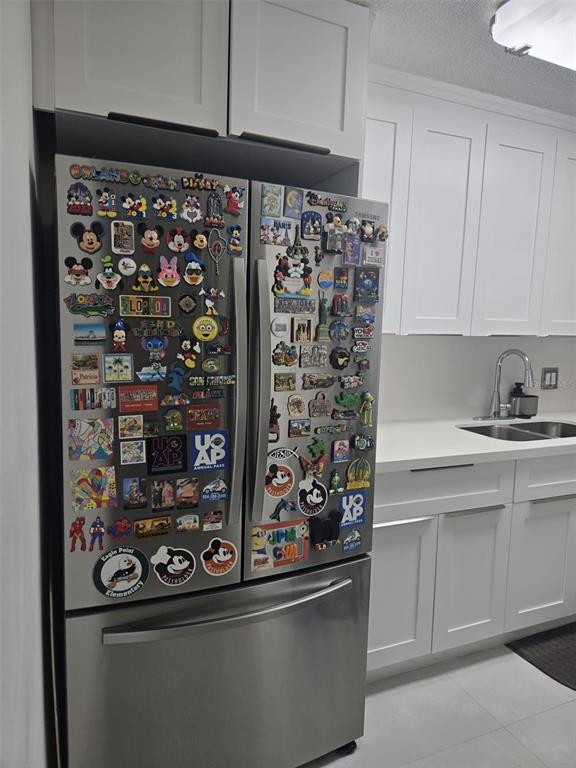 9410 Live Oak Place, Unit 103 Davie, FL 33324 - Photo 10 of 49 a kitchen with a refrigerator and cabinets