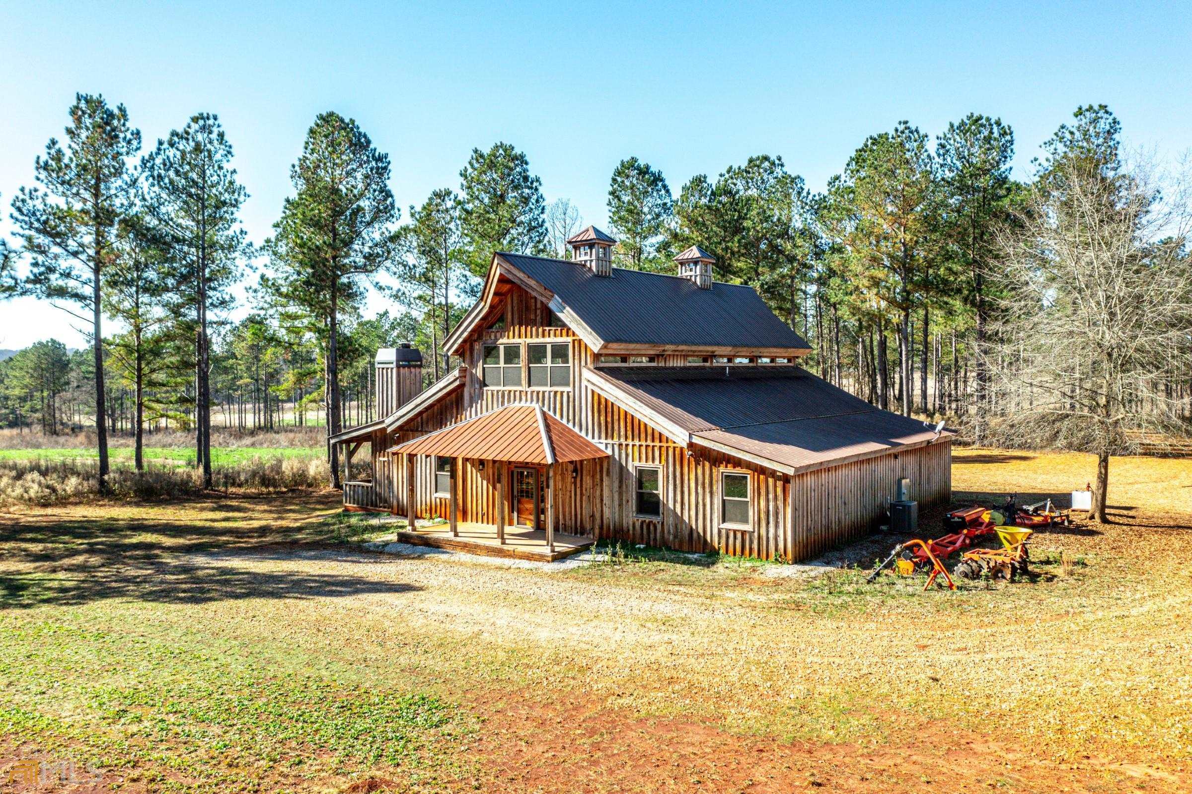 a aerial view of a house with swimming pool and sitting area