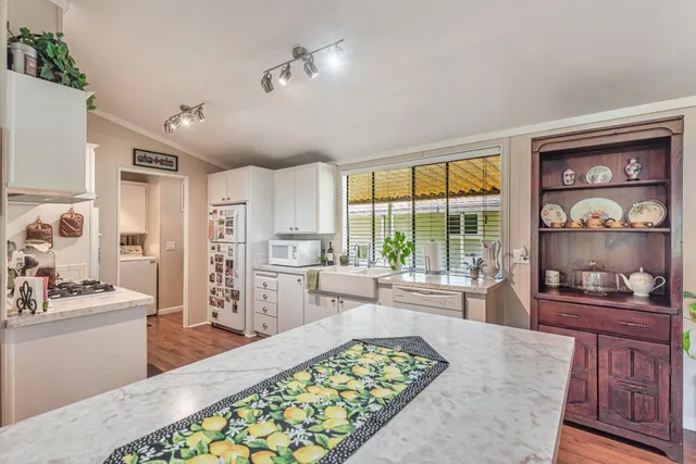 a large bedroom with a bed and wooden floor