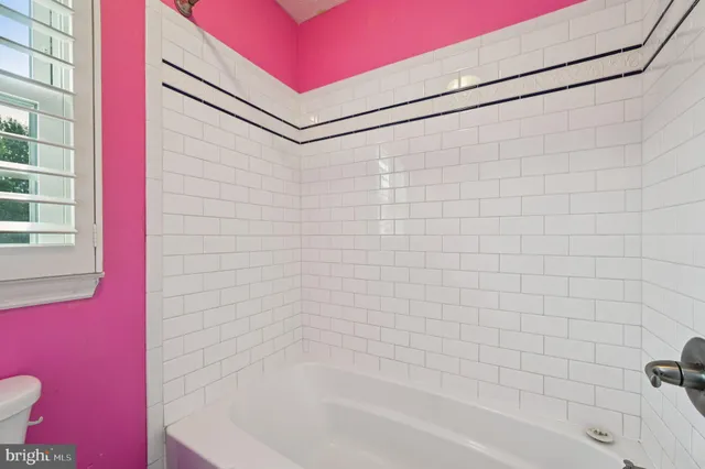 a bathroom with a bathtub and shower