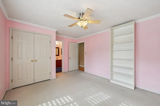 a view of an empty room with a ceiling fan