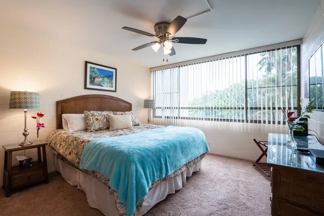 a bedroom with a large bed and a large window