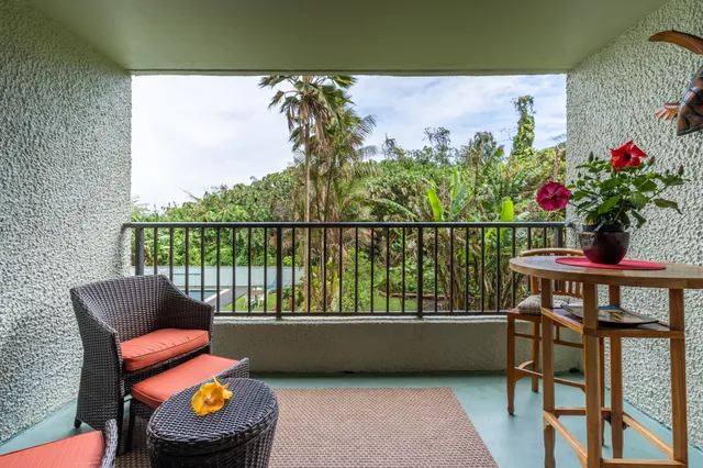 a view of a chairs and table in the balcony
