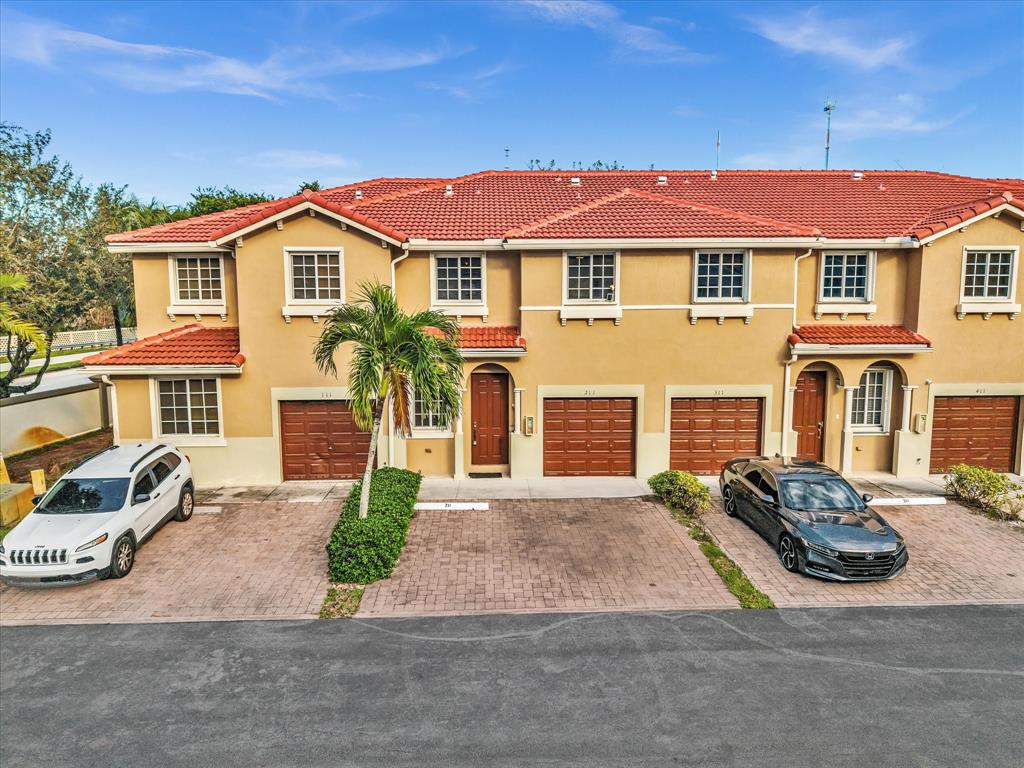 21421 Northwest 13th Court, Unit 211 Miami, FL 33169 - Photo 17 of 18 a front view of a house with a yard