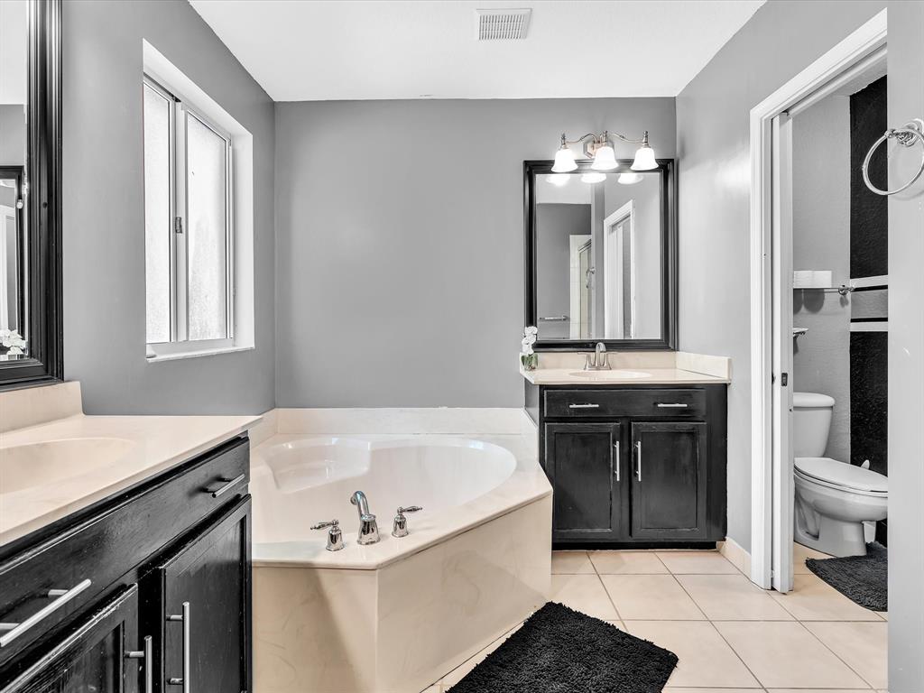 21421 Northwest 13th Court, Unit 211 Miami, FL 33169 - Photo 7 of 18 a bathroom with a bathtub sink and a mirror