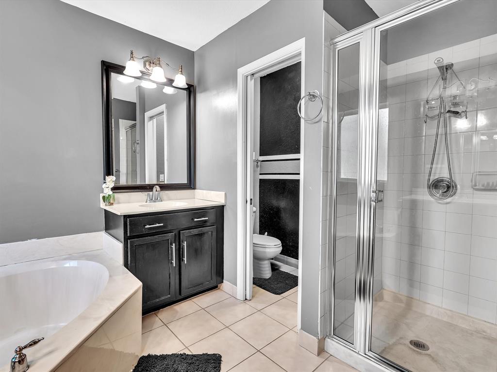 21421 Northwest 13th Court, Unit 211 Miami, FL 33169 - Photo 8 of 18 a bathroom with a double vanity sink a toilet and shower