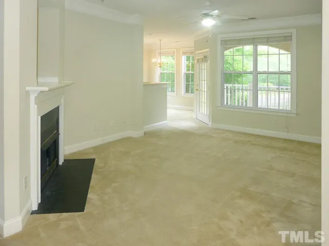 a view of an empty room with a fireplace