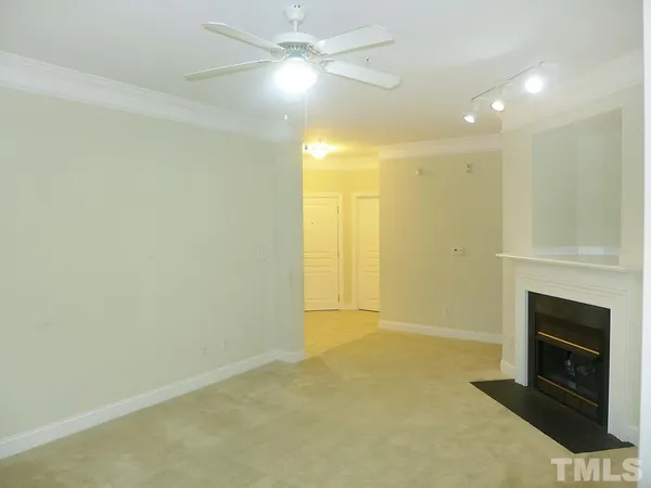 a view of an empty room with a fireplace
