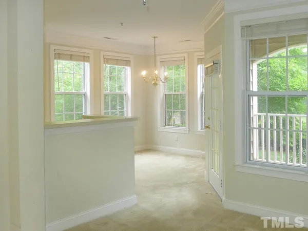 an empty room with windows and outdoor view
