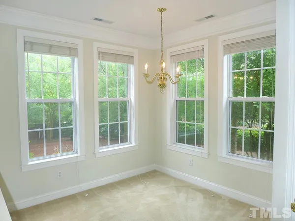a view of an empty room with windows and balcony