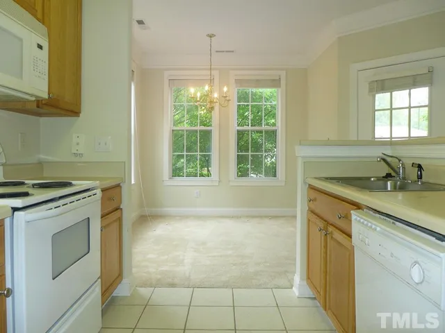 a kitchen with a sink a stove and a refrigerator