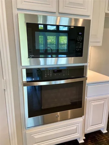 a kitchen with a stove and a window