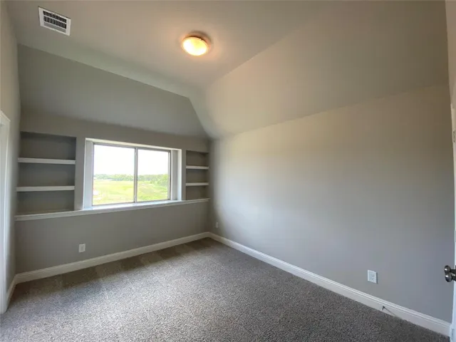 an empty room with windows and mirror fan