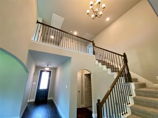 an empty room with wooden floor and window