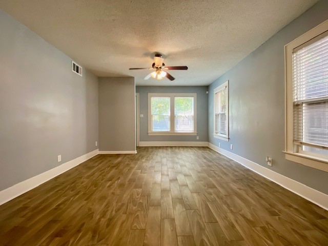 1302 West Pierce Street Houston, TX 77019 - Photo 2 of 12 wooden floor in an empty room with a window
