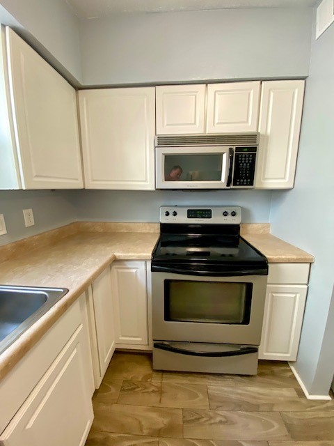 1302 West Pierce Street Houston, TX 77019 - Photo 6 of 12 a kitchen with stainless steel appliances a stove microwave and sink