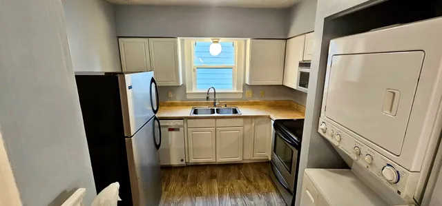 a kitchen with a refrigerator and a sink