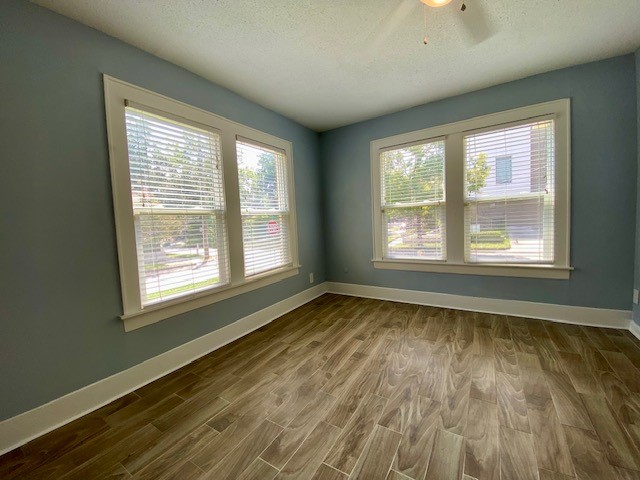 1302 West Pierce Street Houston, TX 77019 - Photo 10 of 12 a view of an empty room with wooden floor and a window