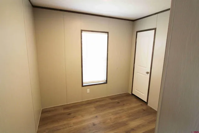 a view of a room with wooden floor