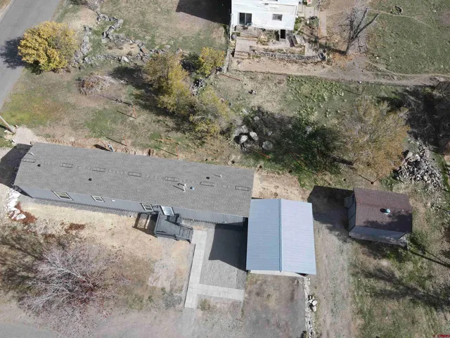 an aerial view of a house with a yard