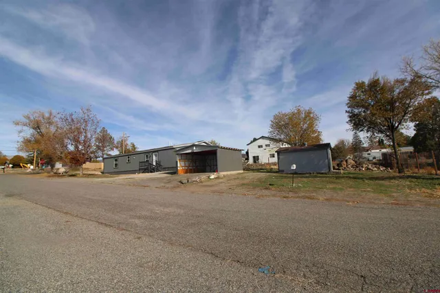 a big house with a yard and large trees