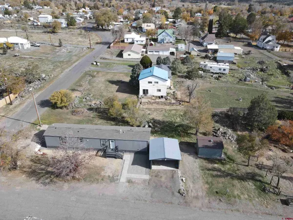 an aerial view of a house with a yard