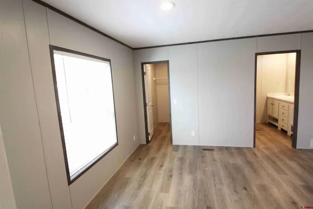 a view of empty room with wooden floor