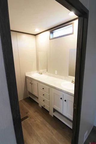 a bathroom with a double vanity sink and mirror