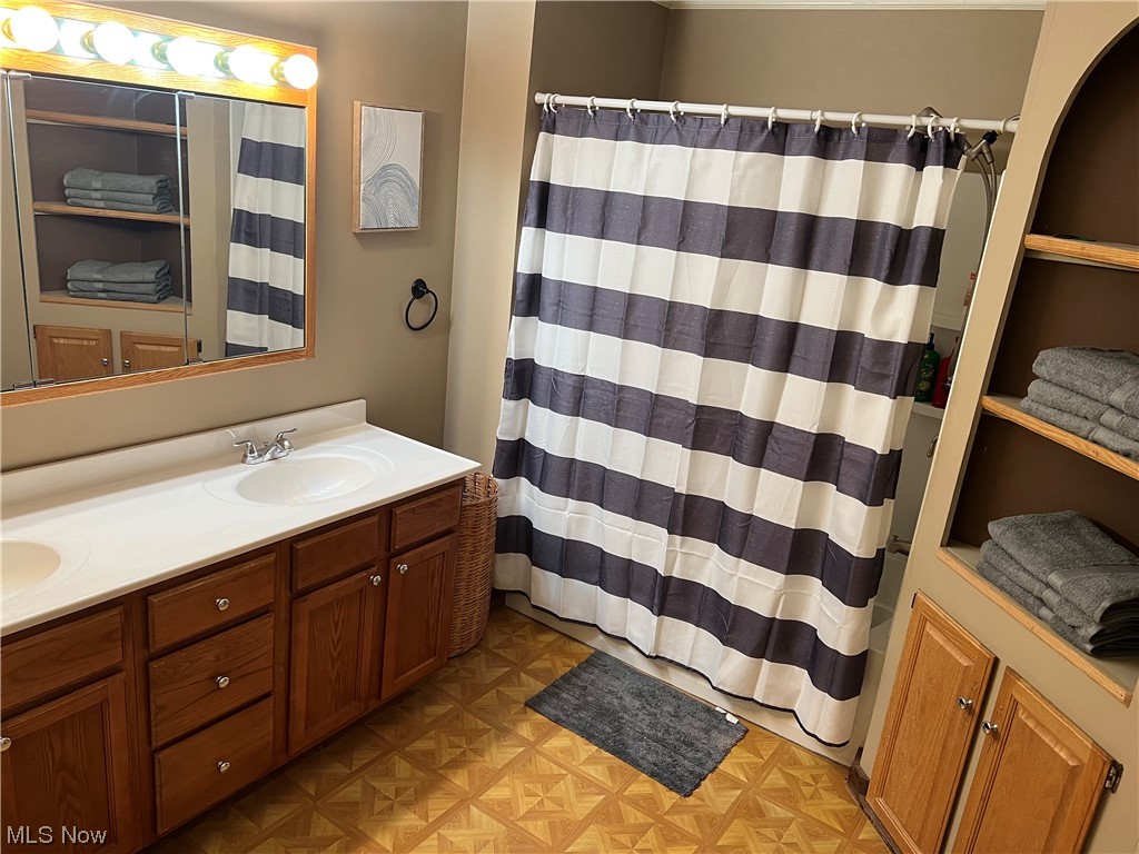 6950 Walker Road Walker, WV 26180 - Photo 14 of 22 Full Bathroom main level with parquet floors and dual vanity