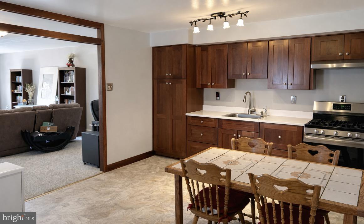 3243 Morrell Avenue Philadelphia, PA 19114 - Photo 5 of 28 a kitchen with a table chairs refrigerator and cabinets