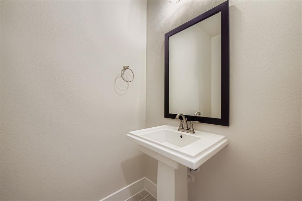158 Sandie Drive Rhome, TX 76078 - Photo 13 of 25 a bathroom with a sink and a mirror