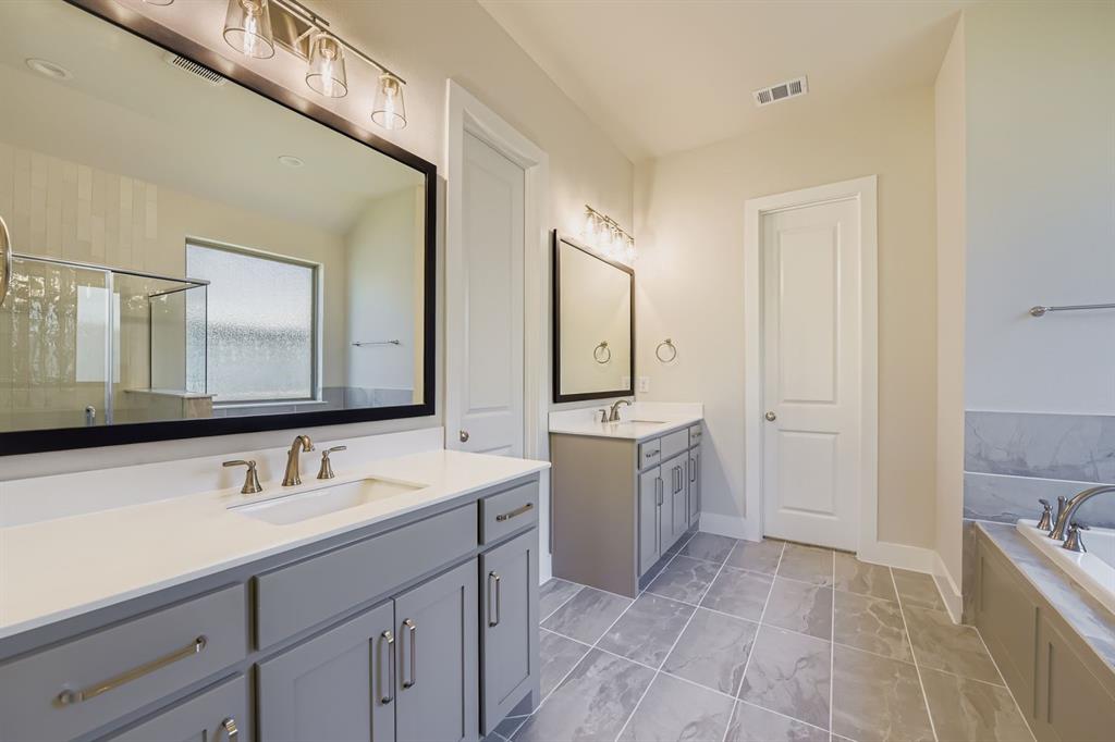 158 Sandie Drive Rhome, TX 76078 - Photo 17 of 25 a bathroom with a sink a mirror and a bathtub