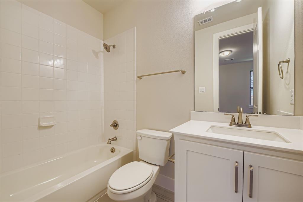 158 Sandie Drive Rhome, TX 76078 - Photo 22 of 25 a bathroom with a toilet a sink a mirror a bathtub and vanity
