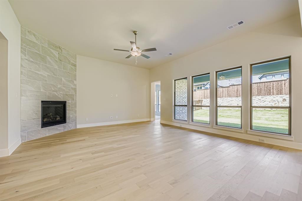 158 Sandie Drive Rhome, TX 76078 - Photo 5 of 25 a view of an empty room with a fireplace and a window