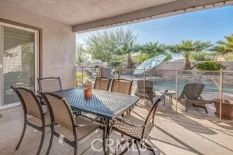 a view of a patio with a table and chairs