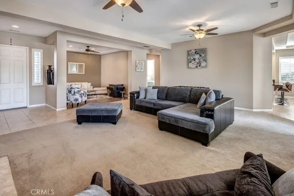 a living room with furniture and a chandelier