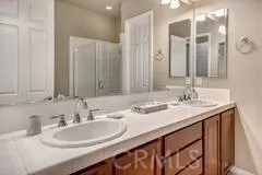 a bathroom with a double vanity sink and a mirror