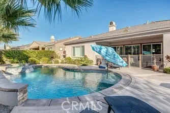 a view of a house with pool and sitting area