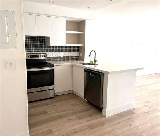 a kitchen with stainless steel appliances granite countertop a stove and a sink