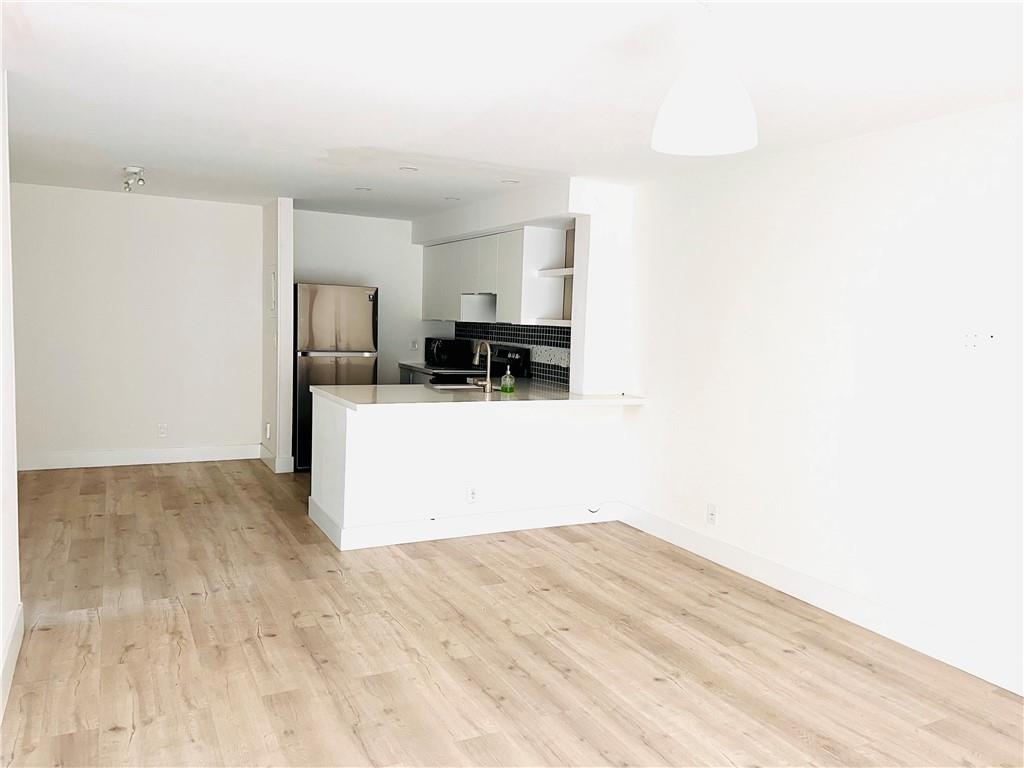 10930 Royal Palm Boulevard, Unit 10930 Coral Springs, FL 33065 - Photo 3 of 11 a kitchen with a refrigerator and a stove top oven
